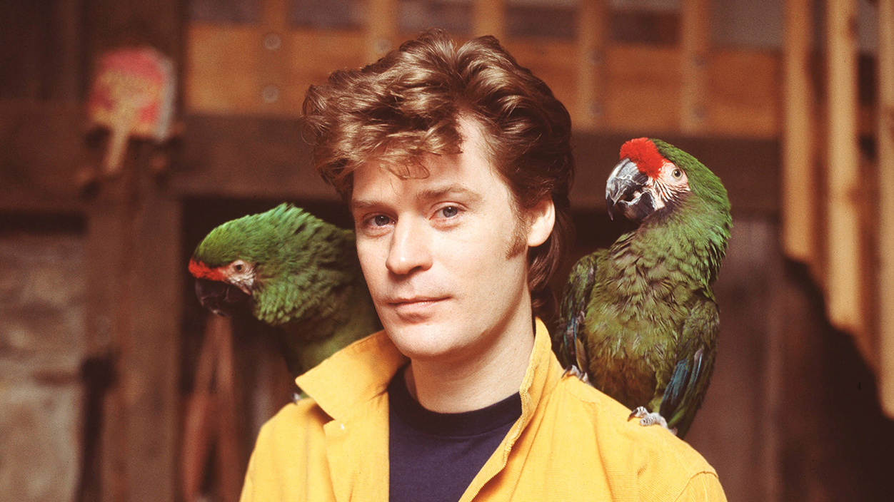 Daryl Hall, of Hall and Oates, portrait, with parrots, Upstate New York, February 1983. (Photo by Michael Putland/Getty Images)